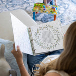 Sunrise to Sunrise NICU memory book open to letter page with botanical wreath and handwritten text