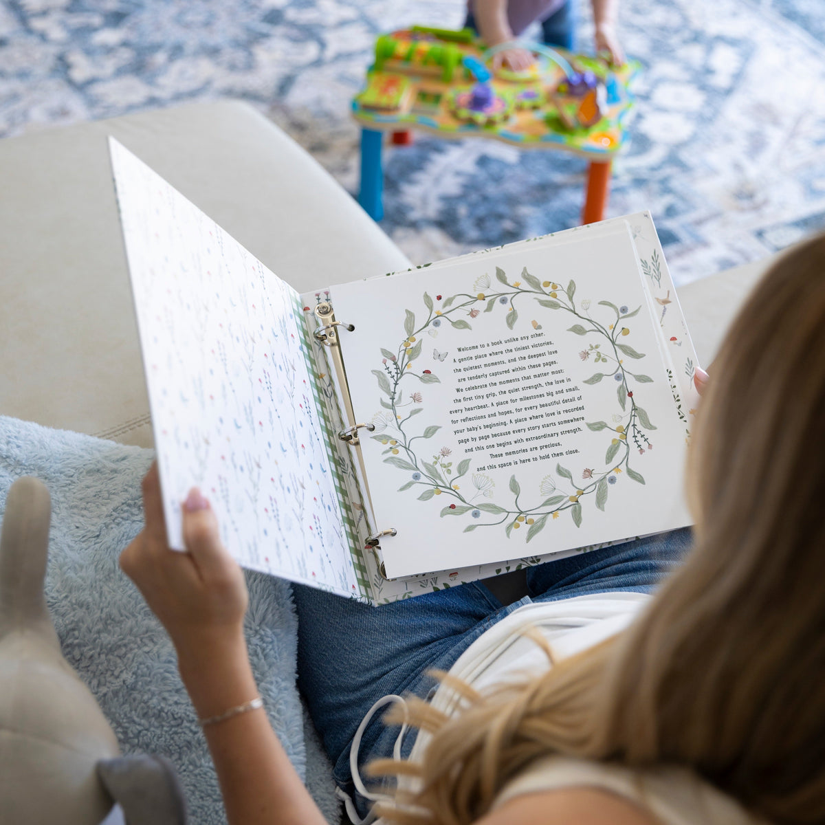 Sunrise to Sunrise NICU memory book open to letter page with botanical wreath and handwritten text